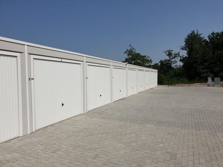 Garagentore in der Schrägansicht, im Hintergrund Bäume